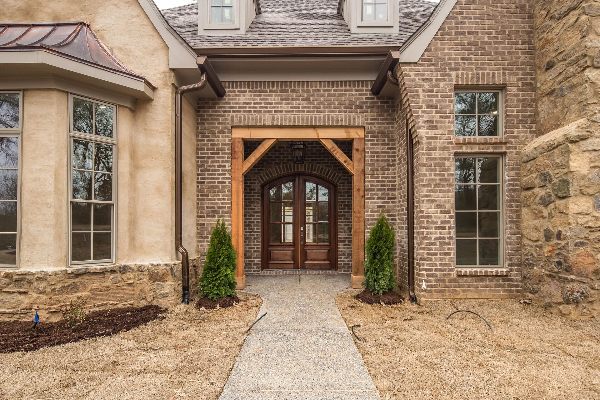 Entry and exterior detail — stone and brick facade